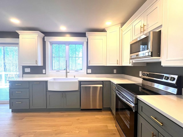 3 Crocket St, Rochester, NH 03867 - kitchen with appliances with stainless steel finishes, a sink, light countertops, light wood-style flooring, and recessed lighting