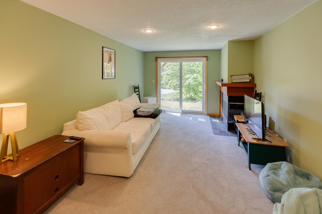 37 Pinehill Ln Unit 2, Lincoln, NH 03251 - living area with light carpet, a fireplace with flush hearth, a textured ceiling, baseboards, and recessed lighting