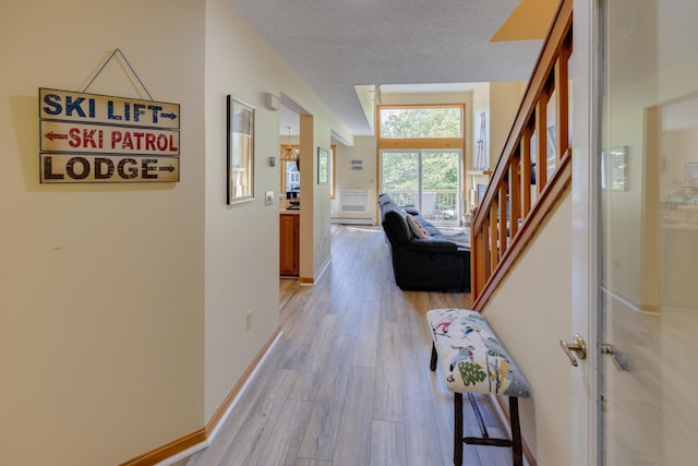 37 Pinehill Ln Unit 2, Lincoln, NH 03251 - corridor featuring light wood-type flooring, stairs, a textured ceiling, and baseboards