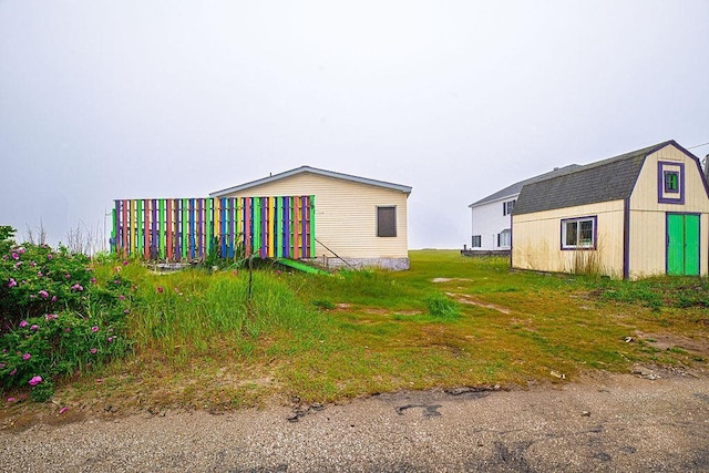19/22 River St, Seabrook, NH 03874 - view of property exterior with an outbuilding and a gambrel roof
