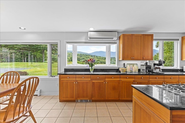 188 Foster Farm Rd, Stowe, VT 05672 - kitchen with a wall mounted air conditioner, healthy amount of natural light, light tile patterned flooring, brown cabinets, and recessed lighting