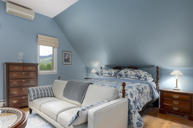 188 Foster Farm Rd, Stowe, VT 05672 - bedroom with a wall mounted air conditioner, wood finished floors, and lofted ceiling