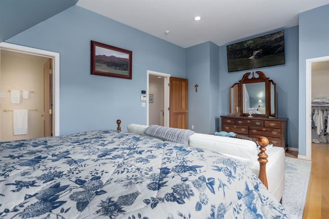 188 Foster Farm Rd, Stowe, VT 05672 - bedroom featuring wood finished floors, a walk in closet, a closet, and recessed lighting