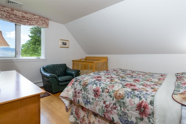 188 Foster Farm Rd, Stowe, VT 05672 - bedroom with light wood-style floors, a baseboard heating unit, and lofted ceiling