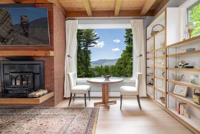 188 Foster Farm Rd, Stowe, VT 05672 - dining area featuring wood finished floors, a mountain view, wood ceiling with exposed beams, and a wood stove