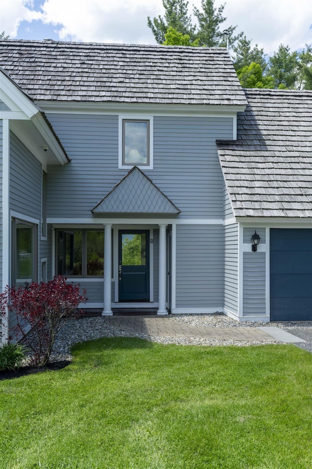188 Foster Farm Rd, Stowe, VT 05672 - view of exterior entry with a yard and a garage