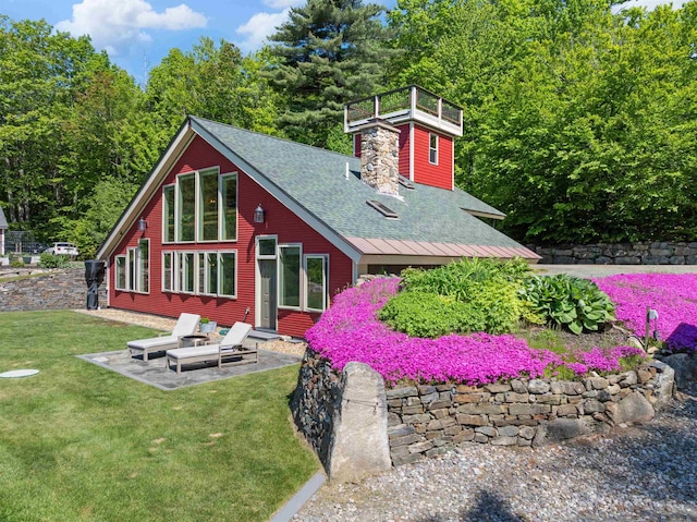 151 Brock Hill Rd, Bridgewater, NH 03222 - view of front of property featuring a shingled roof, a patio area, a front lawn, and a chimney