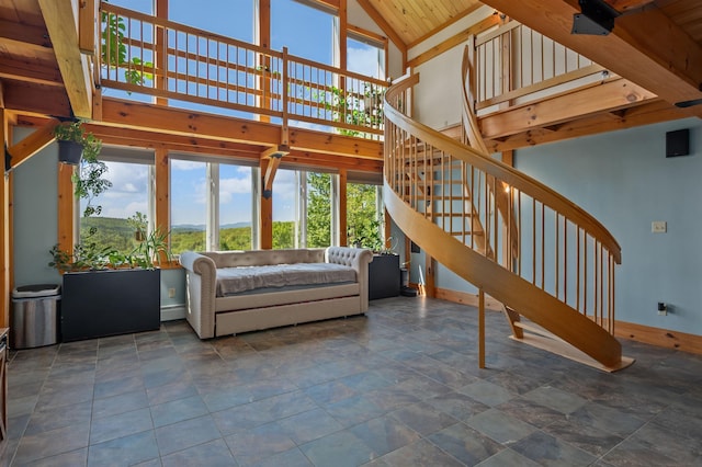 151 Brock Hill Rd, Bridgewater, NH 03222 - living room featuring stairs, baseboards, stone finish flooring, and high vaulted ceiling