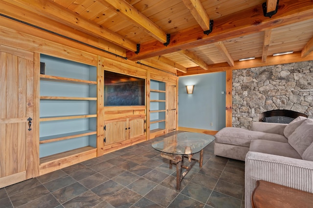 151 Brock Hill Rd, Bridgewater, NH 03222 - living area with wooden ceiling with exposed beams, a stone fireplace, and baseboards