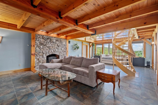 151 Brock Hill Rd, Bridgewater, NH 03222 - living room with wood ceiling with exposed beams, baseboards, stone tile floors, stairs, and a stone fireplace