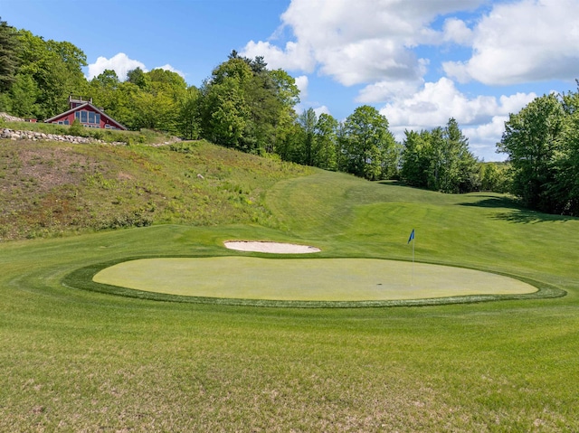 151 Brock Hill Rd, Bridgewater, NH 03222 - view of community with view of golf course, a yard, a putting area, and view of wooded area
