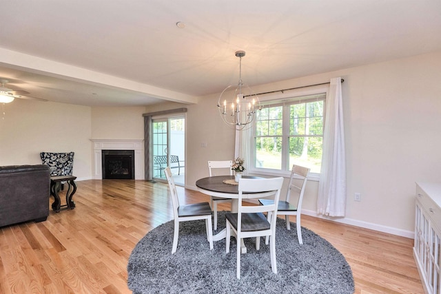 264 Woodview Way, Manchester, NH 03102 - dining room featuring light wood-style floors, a chandelier, plenty of natural light, and a fireplace