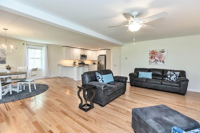 264 Woodview Way, Manchester, NH 03102 - living area featuring light wood finished floors, a chandelier, ceiling fan, and baseboards