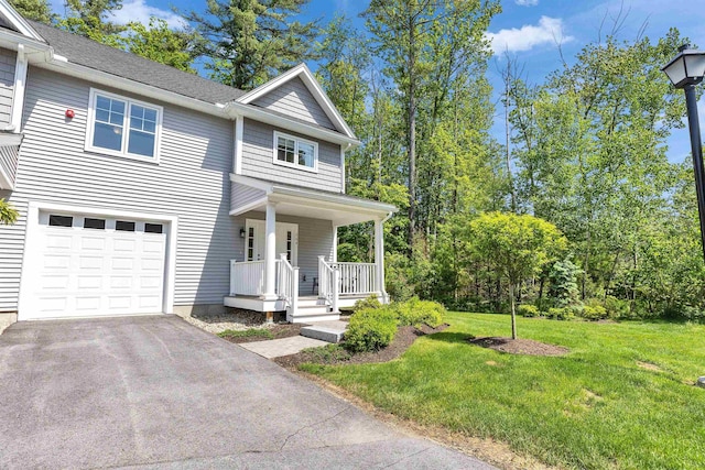 264 Woodview Way, Manchester, NH 03102 - view of front of property featuring covered porch, an attached garage, a front yard, and asphalt driveway