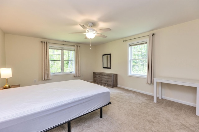 264 Woodview Way, Manchester, NH 03102 - bedroom with multiple windows, light carpet, baseboards, and ceiling fan