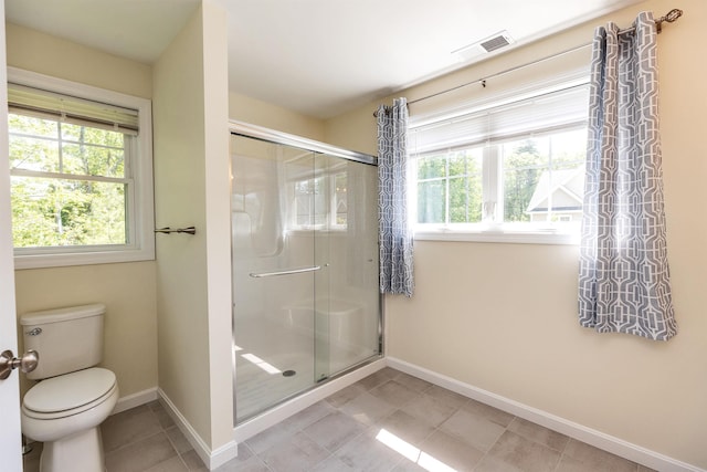 264 Woodview Way, Manchester, NH 03102 - bathroom featuring baseboards, a stall shower, toilet, and tile patterned floors