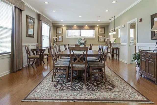 264 Woodview Way, Manchester, NH 03102 - dining space featuring plenty of natural light, wood finished floors, a wainscoted wall, ornamental molding, and a decorative wall