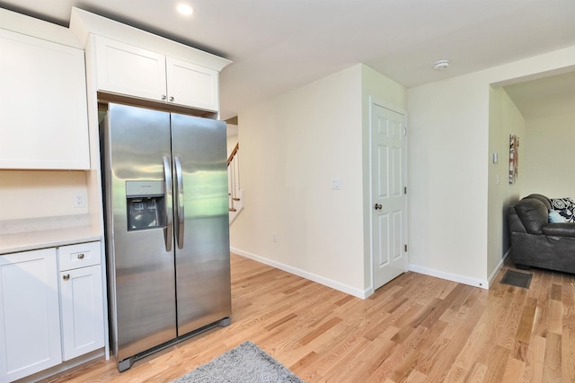 264 Woodview Way, Manchester, NH 03102 - kitchen featuring stainless steel fridge with ice dispenser, light wood-style flooring, baseboards, white cabinetry, and recessed lighting