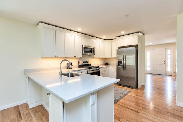 264 Woodview Way, Manchester, NH 03102 - kitchen featuring appliances with stainless steel finishes, a sink, light countertops, light wood-style floors, and recessed lighting