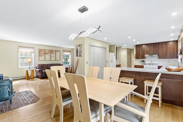 12 Old Fort Ln, Dunbarton, NH 03046 - dining room with a wood stove, light wood finished floors, recessed lighting, and baseboard heating