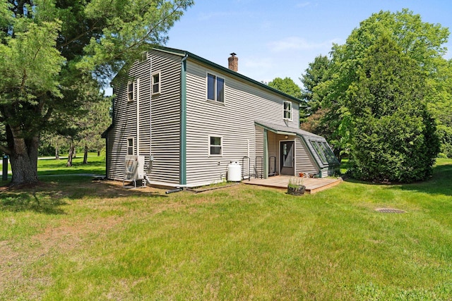 14 Hideaway Ln, Williston, VT 05495 - back of property featuring a chimney, a lawn, and a wooden deck
