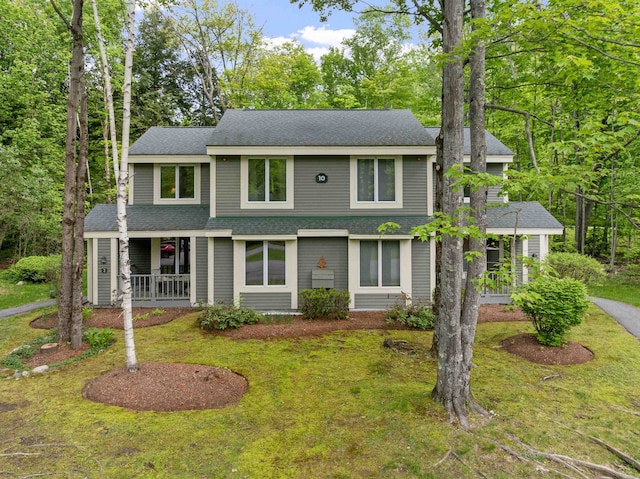 10 Mountain Brook Cir Unit 2, Lincoln, NH 03251 - view of front of house with a porch, a shingled roof, and a front lawn