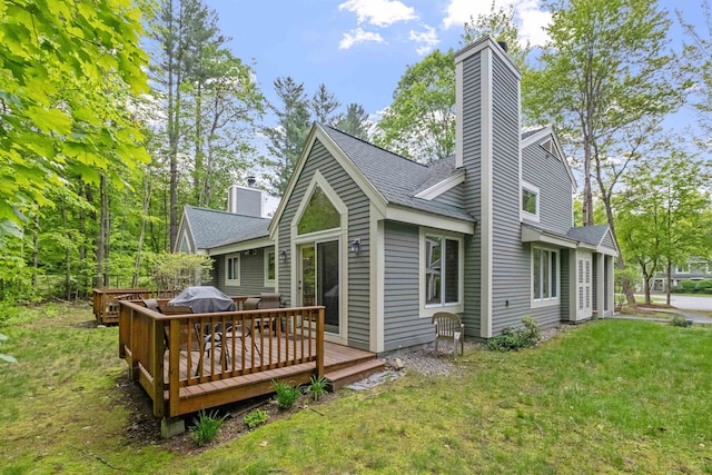 10 Mountain Brook Cir Unit 2, Lincoln, NH 03251 - back of property featuring a yard, a chimney, a wooden deck, and a shingled roof