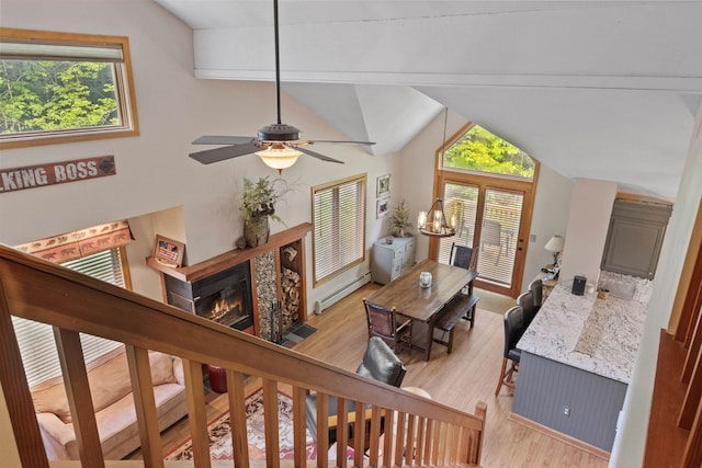 10 Mountain Brook Cir Unit 2, Lincoln, NH 03251 - living room featuring a baseboard radiator, lofted ceiling, light wood-style floors, a ceiling fan, and a fireplace with flush hearth