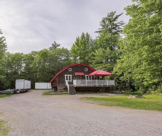 594 Suncook Valley Rd, Alton, NH 03809 - view of front of property with a wooden deck, driveway, and view of scattered trees