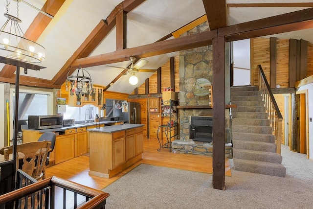 594 Suncook Valley Rd, Alton, NH 03809 - kitchen featuring a chandelier, stainless steel microwave, wooden walls, a stone fireplace, and beam ceiling