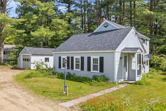 37 Robin St, Franklin, NH 03235 - view of front of house with roof with shingles, dirt driveway, an outbuilding, a detached garage, and a chimney