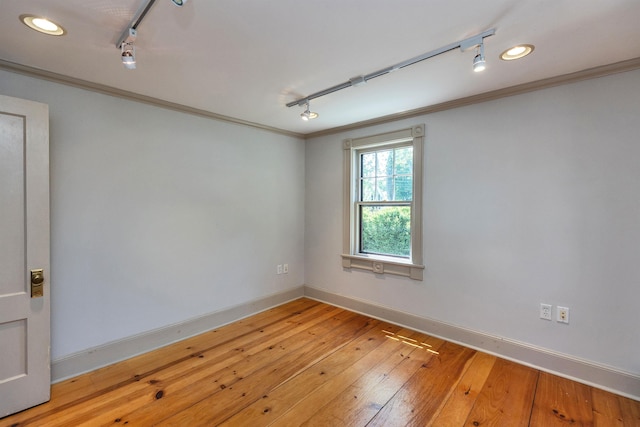 3 Foundry St, Amherst, NH 03031 - spare room featuring track lighting, crown molding, baseboards, and light wood-style floors