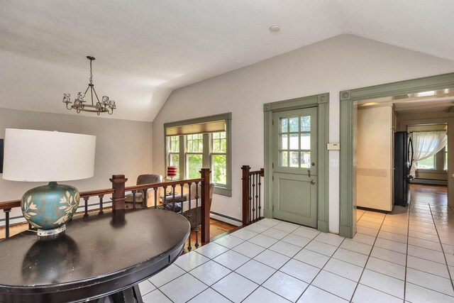 3 Foundry St, Amherst, NH 03031 - dining room featuring vaulted ceiling, a baseboard heating unit, healthy amount of natural light, a chandelier, and light tile patterned flooring