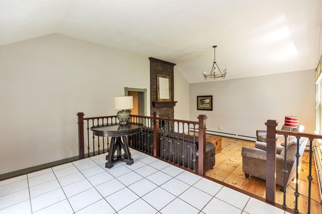 3 Foundry St, Amherst, NH 03031 - hall featuring vaulted ceiling, an upstairs landing, a chandelier, baseboards, and tile patterned flooring