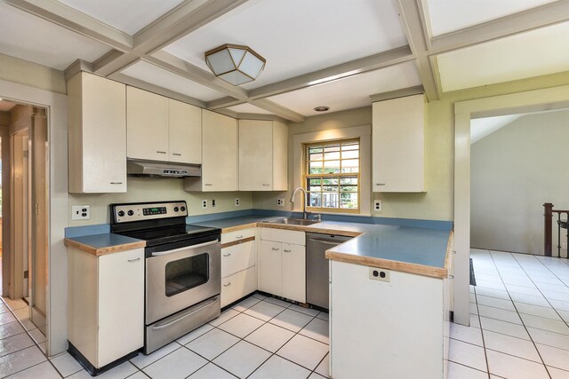 3 Foundry St, Amherst, NH 03031 - kitchen with stainless steel appliances, a sink, coffered ceiling, under cabinet range hood, and light tile patterned floors