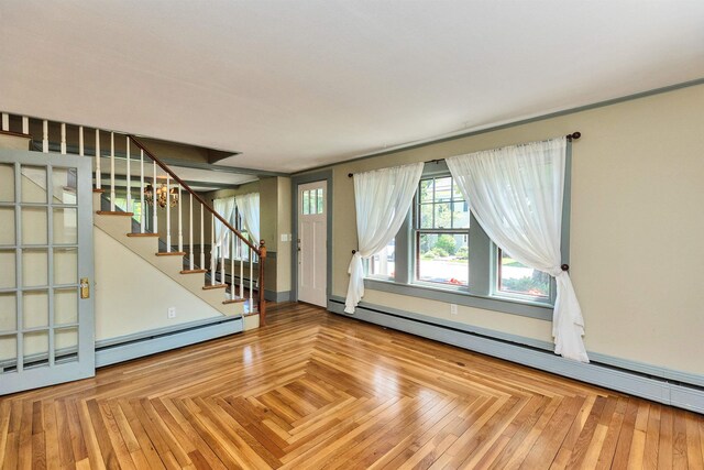 3 Foundry St, Amherst, NH 03031 - unfurnished living room with baseboard heating, stairs, and a baseboard radiator