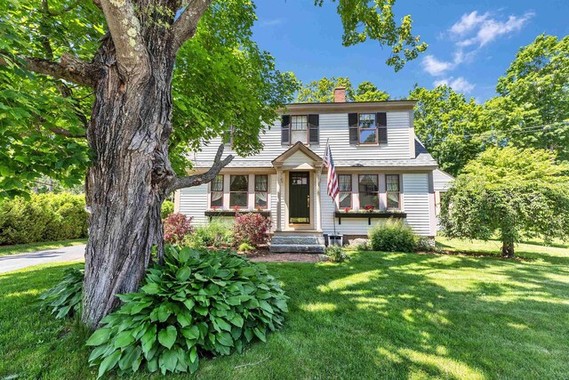 3 Foundry St, Amherst, NH 03031 - view of front of property featuring a front yard and a chimney