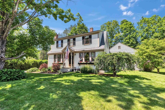3 Foundry St, Amherst, NH 03031 - view of front of home with a chimney and a front lawn