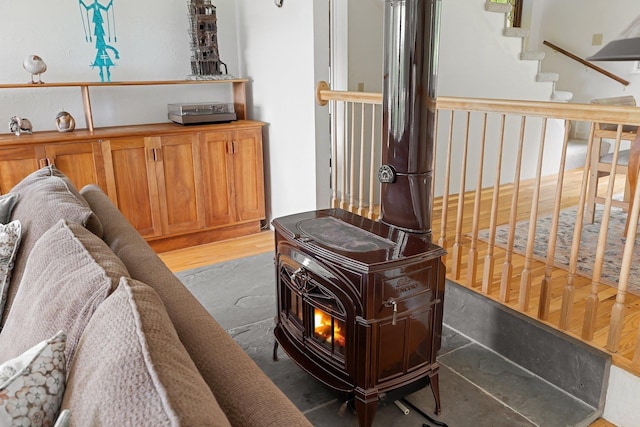 1065 Center Fayston Rd, Fayston, VT 05660 - living area featuring a wood stove, light wood-style floors, and stairs