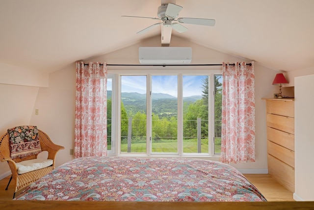 1065 Center Fayston Rd, Fayston, VT 05660 - bedroom with lofted ceiling, a wall mounted air conditioner, light wood-style flooring, a mountain view, and ceiling fan