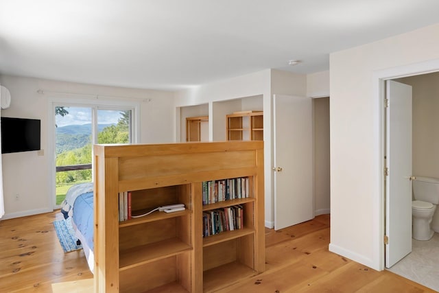 1065 Center Fayston Rd, Fayston, VT 05660 - bedroom featuring access to exterior, light wood-style flooring, connected bathroom, and baseboards