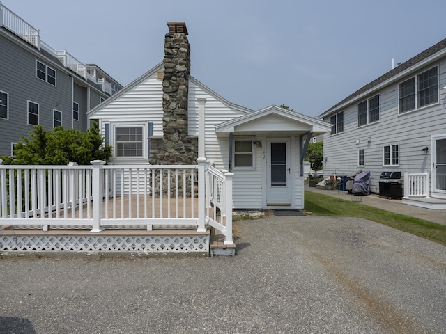 182 Kings Hwy, Hampton, NH 03842 - view of front of home with a deck and a chimney