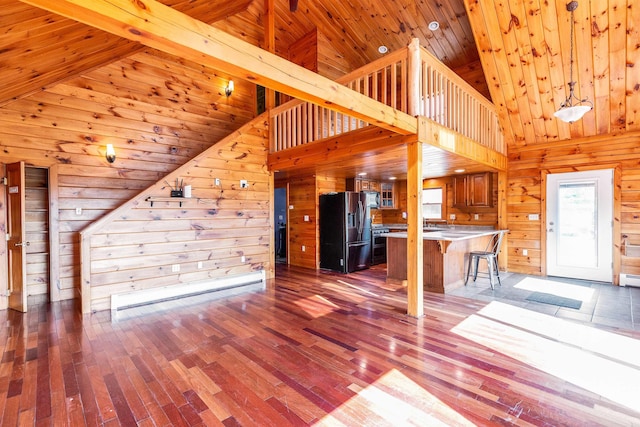 201 Deering Center Rd, Deering, NH 03244 - unfurnished living room with wooden walls, hardwood / wood-style flooring, wood ceiling, high vaulted ceiling, and baseboard heating