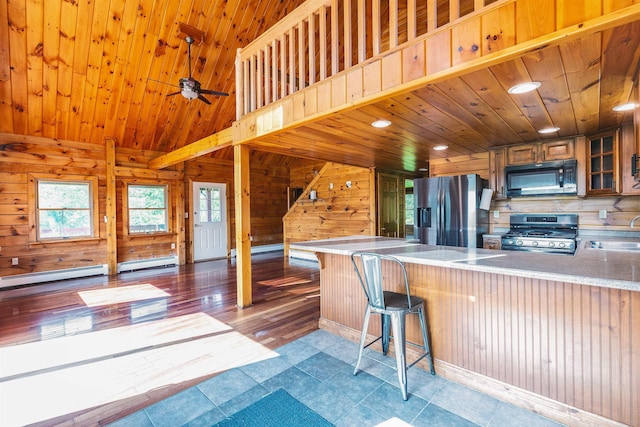 201 Deering Center Rd, Deering, NH 03244 - kitchen featuring appliances with stainless steel finishes, a sink, a peninsula, wooden walls, and wood ceiling