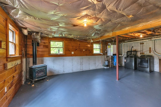 201 Deering Center Rd, Deering, NH 03244 - basement with washer and dryer, a wood stove, wooden walls, and a water pressure tank