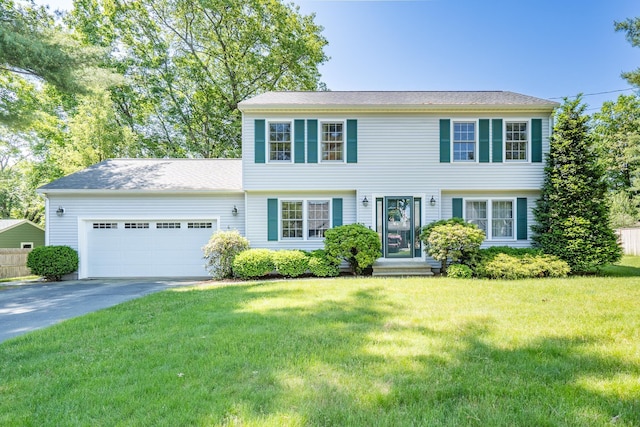 4 Edith Ave, Nashua, NH 03064 - colonial home featuring an attached garage, concrete driveway, and a front yard