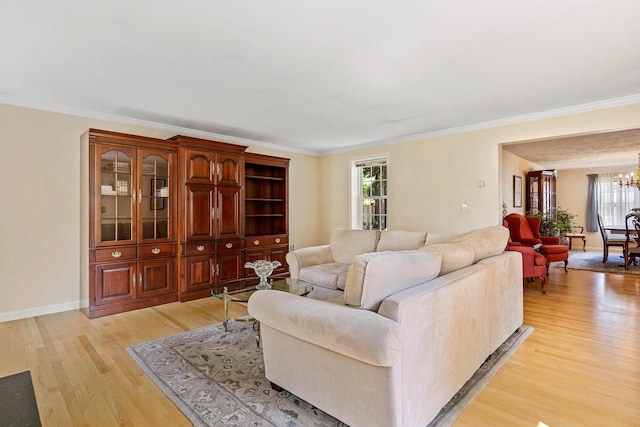 4 Edith Ave, Nashua, NH 03064 - living area with healthy amount of natural light, light wood-type flooring, a chandelier, crown molding, and baseboards