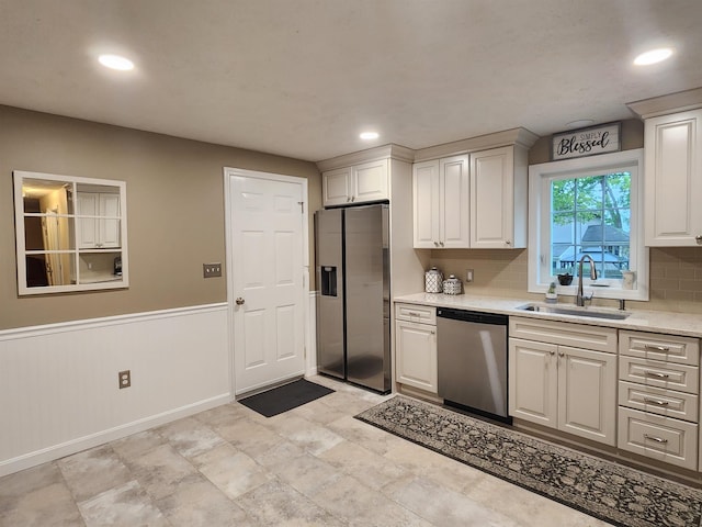 4 Edith Ave, Nashua, NH 03064 - kitchen featuring stainless steel appliances, a sink, white cabinetry, tasteful backsplash, and recessed lighting