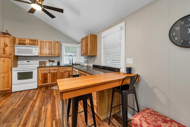 6 Chalet Dr, Gilford, NH 03249 - kitchen featuring white appliances, vaulted ceiling, wood finished floors, dark countertops, and ceiling fan
