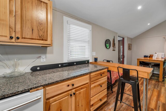 6 Chalet Dr, Gilford, NH 03249 - kitchen featuring wood finished floors, vaulted ceiling, dishwasher, dark stone countertops, and an office area